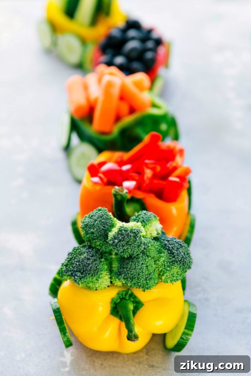 Festive Veggie Train Platter with Dip A playful Christmas or birthday party snack: vibrant vegetables arranged in the shape of a train, perfect for serving with a delicious veggie dip.