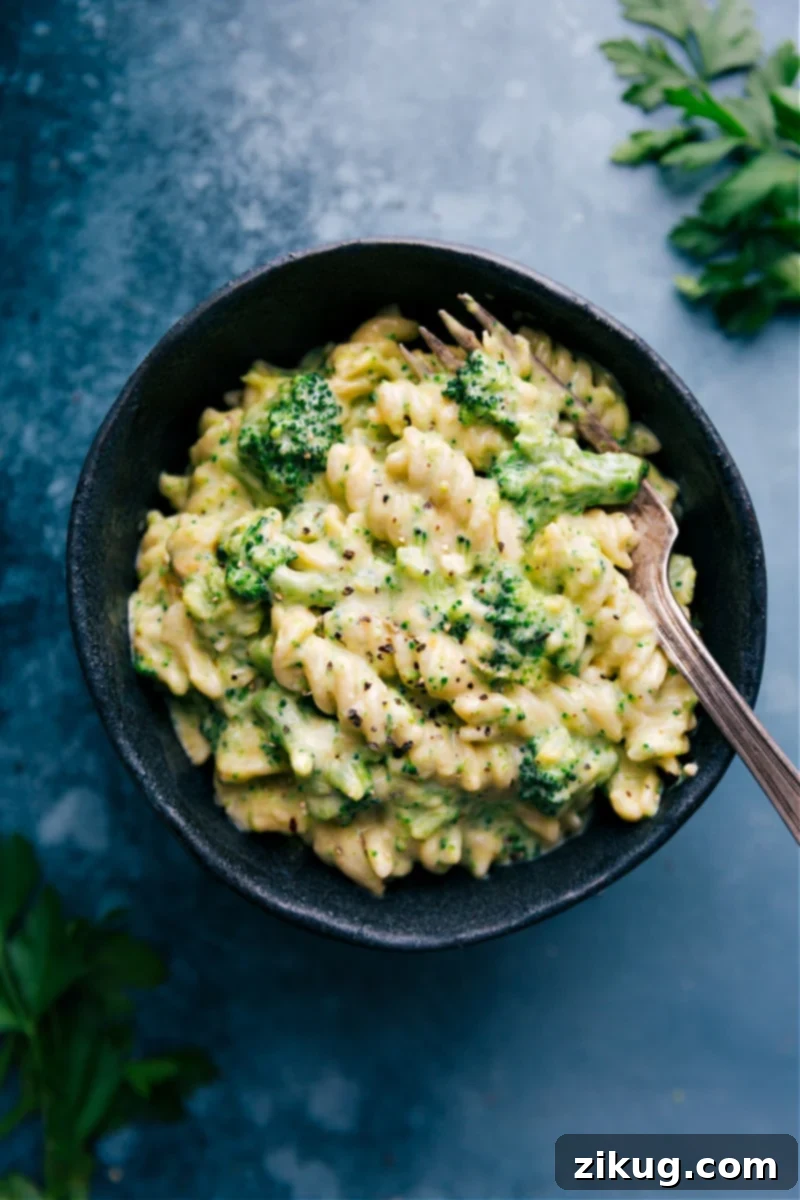 Broccoli Pasta in a bowl with a fork, ready to eat. A quick, easy, and flavorful family meal.