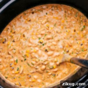 Crockpot White Chicken Chili in a bowl with toppings.