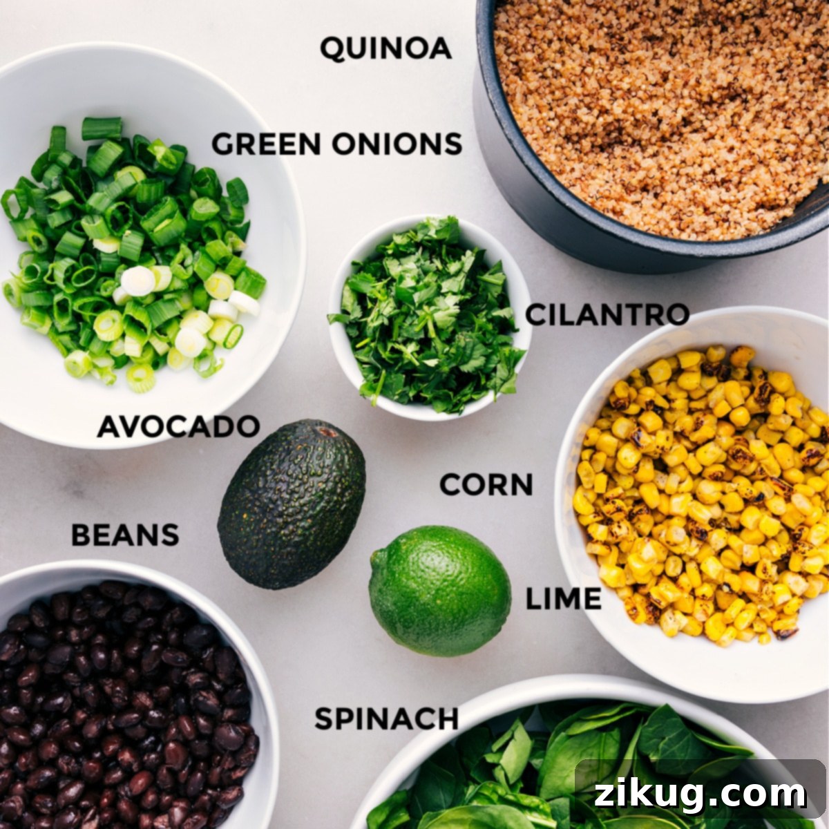 Essential Ingredients for a Delicious Quinoa Corn Salad A beautiful display of fresh ingredients for Quinoa Corn Salad: ripe avocado, bright corn kernels, dark black beans, vibrant cilantro, and chopped green onions.