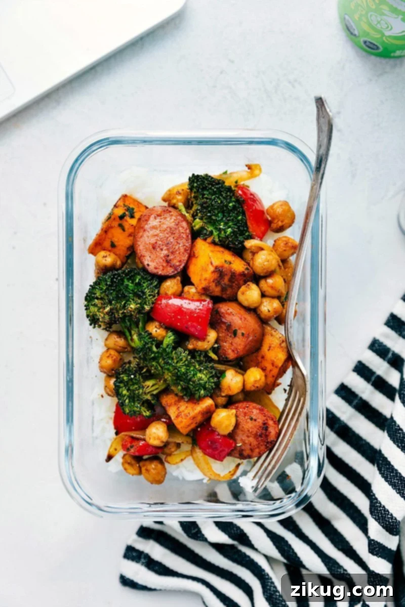 You're going to adore One-Pan Sausage and Chickpeas! This effortlessly delicious meal, featuring onions, sweet potatoes, broccoli, and sweet bell pepper in a zesty Mexican-inspired seasoning, offers minimal prep and quick cleanup, perfect for healthy meal prep. #mealprep #healthydinner #onepansausageandchickpeas Image of One-Pan Sausage and Chickpeas in a meal prep container, showcasing versatile serving options