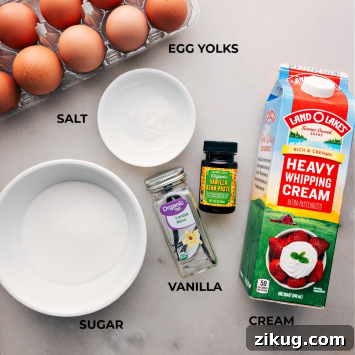 Ingredients spread out meticulously for making the perfect Crème Brûlée recipe, including fresh eggs, granulated sugar, and rich cream.