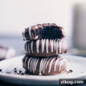 Finished Oreo Truffles with chocolate coating and white chocolate drizzle.