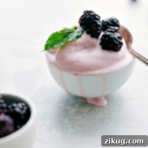 A scoop of homemade Strawberry Frozen Yogurt, smooth and creamy.