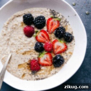 Finished breakfast dish topped with fresh berries, chia seeds, and honey, offering a warm and healthy start to the day.
