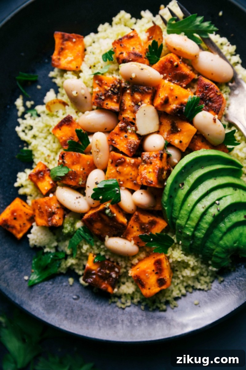 Ready to Enjoy - Couscous and Sweet Potato Dish with Fresh Herbs Couscous and sweet potato recipe garnished with fresh herbs and seasonings, served and ready to eat.