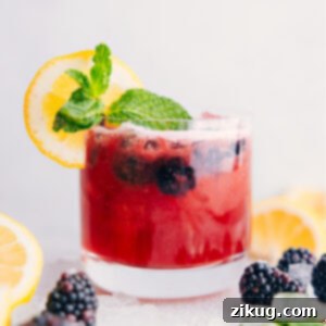 Delicious Blackberry Lemonade served in a glass with fresh berries.