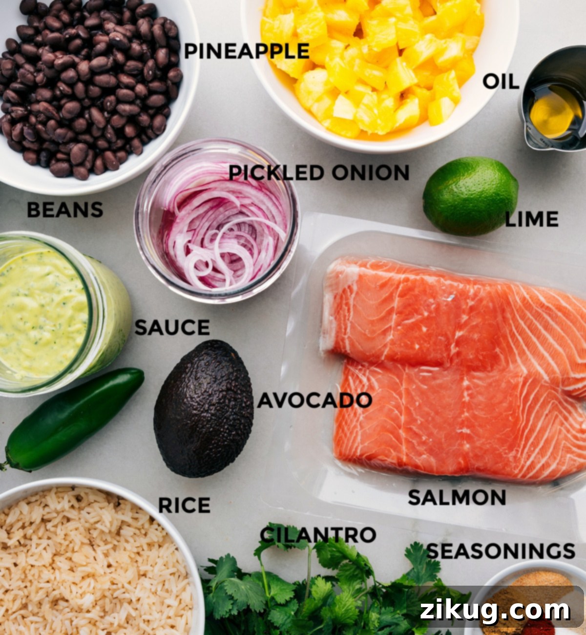 Ingredients In Mojo Salmon Bowls Prepped A colorful array of fresh ingredients laid out, including salmon fillets, lime, avocado, orange, cilantro, and various spices, prepped for Mojo Salmon Bowls assembly.