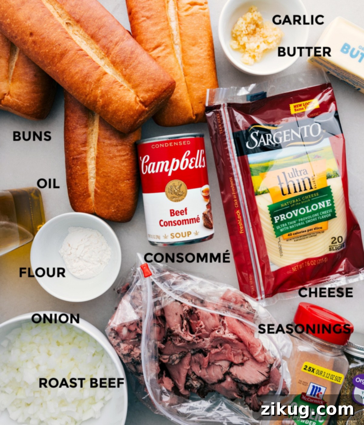 Key Ingredients for Delicious 15-Minute Easy French Dip Sandwiches All the fresh and carefully selected ingredients, including soft white sub buns, high-quality olive oil, all-purpose flour, finely diced yellow onions, premium deli roast beef slices, minced garlic, unsalted butter, creamy Swiss or provolone cheese, aromatic dried thyme, rich beef consommé, and garlic powder, perfectly prepped and laid out for the efficient assembly of these 15-minute easy French Dip Sandwiches.