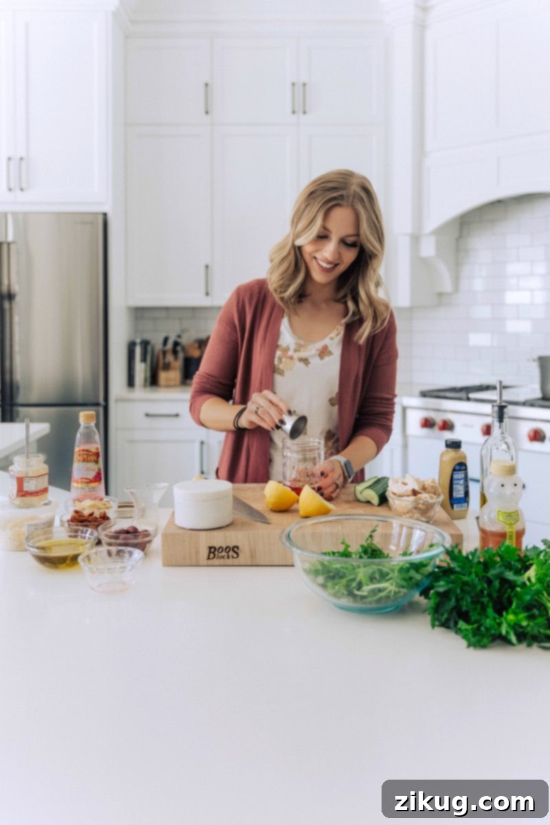Chelsea preparing the zesty oregano-lemon vinaigrette for her Mediterranean Pasta Salad, showcasing the fresh ingredients.