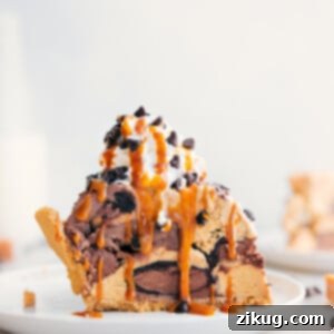 Ice Cream Pie Slice with Toppings Slice of Ice Cream Pie with whipped cream, drizzle of caramel, and chocolate chips on top.