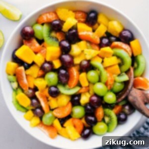 A big bowl of the Tropical Fruit Salad, glistening with honey-lime dressing.
