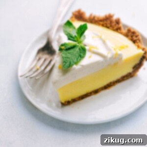 Slice of Lemon Pie on a plate with fresh mint on top, representing the finished recipe.
