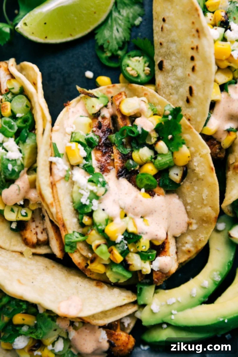 Savory Chicken Tacos Ready to Serve Delicious grilled chicken tacos with corn and avocado topping