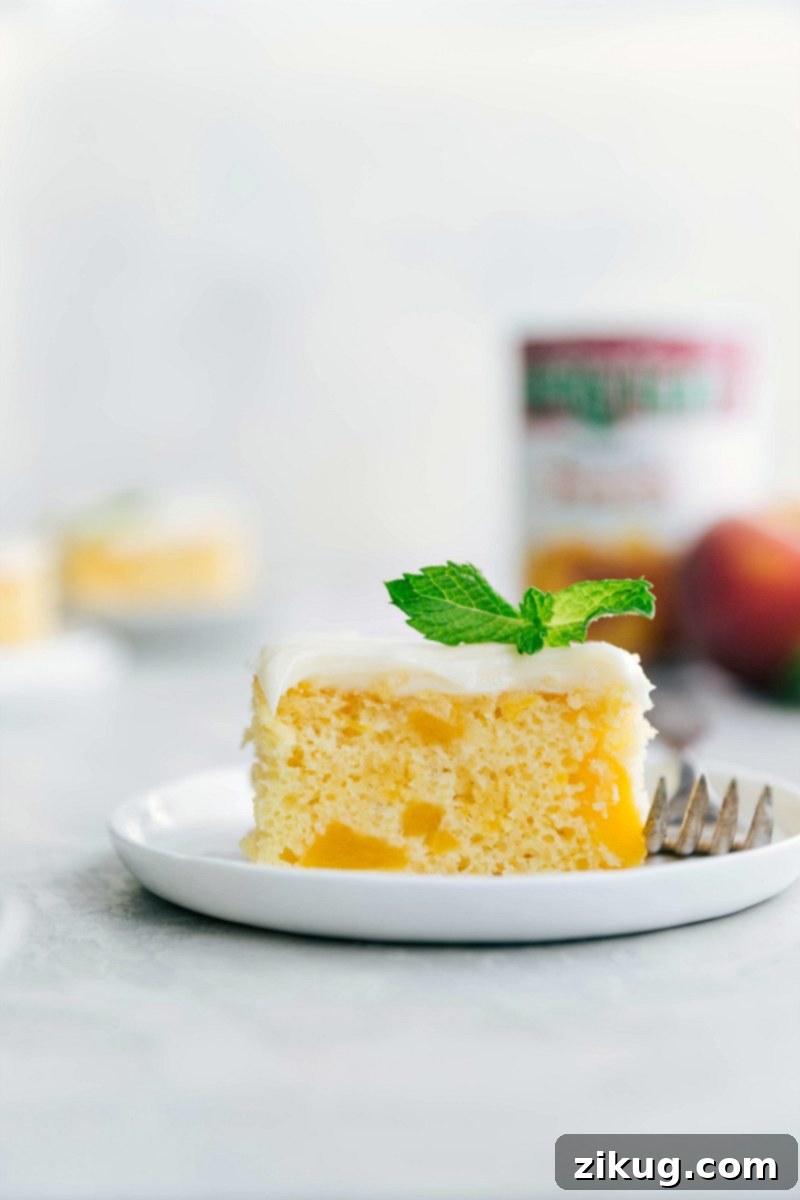 Delicious Peaches and Cream Cake A beautifully frosted Peaches and Cream Cake, adorned with creamy white frosting and garnished with fresh peach slices, ready to be served. The golden-brown edges of the cake are visible, promising a soft and moist interior.