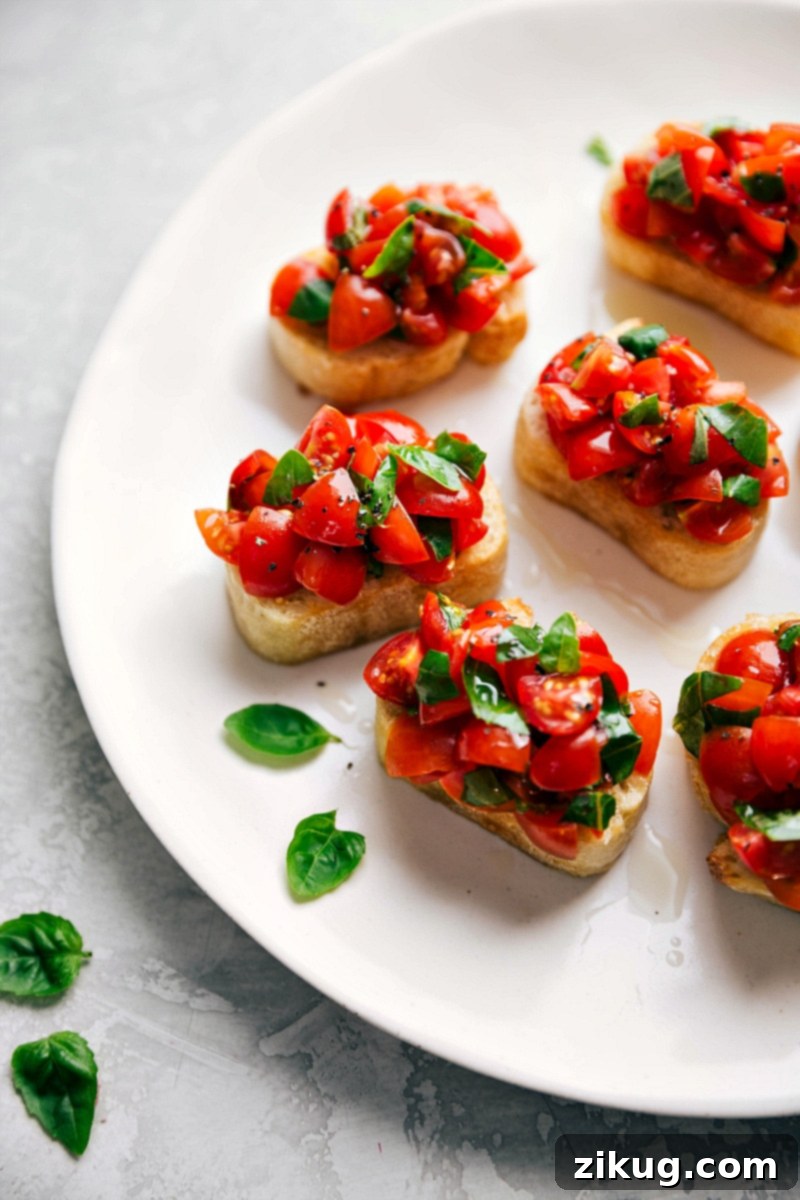 Authentic Italian Bruschetta Al Pomodoro appetizer with fresh tomatoes and basil on toasted bread.