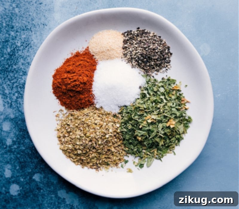 The best ever Sausage Kabobs are simple to make, nutritious, and loaded with flavor! Recipe via ChelseasMessyApron #dinner #quick #easy #healthy #whole #whole30 #keto #veggies #grilled #summer #sausage #kabobs Close-up image of the dry seasoning blend, including dried oregano, dried parsley flakes, garlic powder, paprika, salt, and black pepper, neatly arranged on a plate.