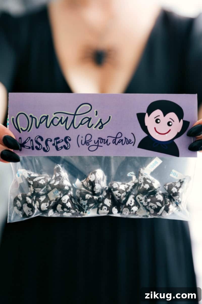 6 fun and festive easy Halloween bags filled with delicious treats! These candies/treats are put in a snack-size ziplock bag and you can staple on the FREE printable bag toppers! via chelseasmessyapron.com #halloween #gift #favor #party #dessert #candy #treat #easy #quick #free #printable #witch #pumpkin #dracula #zombie #mummy #ghost #skeleton #monster #zombies #kids #healthy #healthier #simple #fun #halloween #decor A festive Halloween treat bag featuring a 'Dracula Kisses' theme, filled with delicious Hershey's Kisses. The bag is sealed with a free printable topper, part of a set of 6 easy and fun Halloween ideas for gifts, favors, or parties.