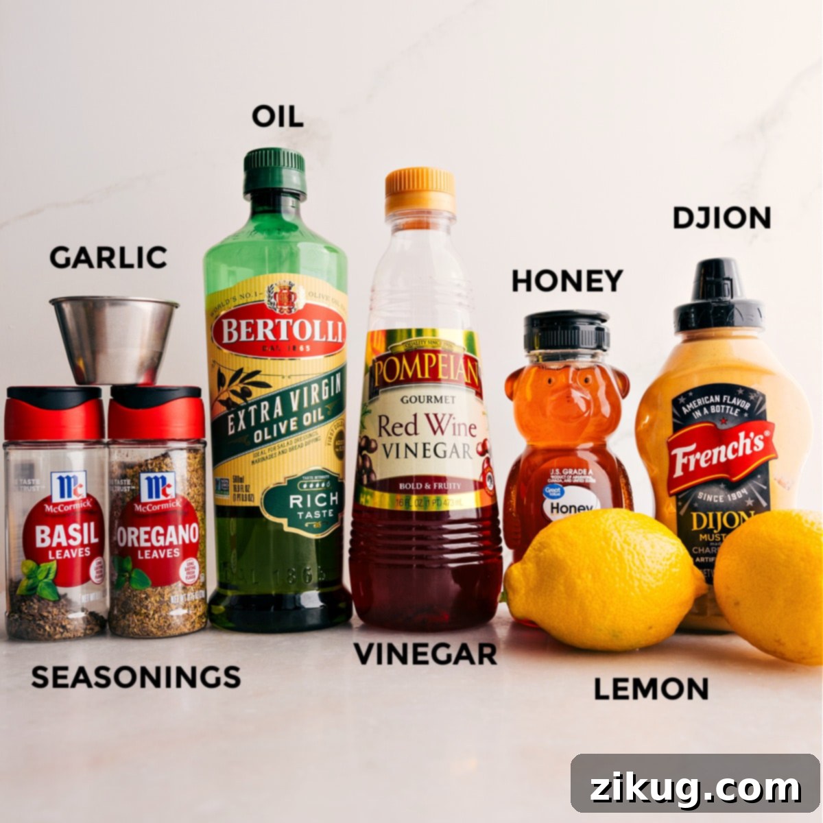 Fresh ingredients for the zesty lemon dressing: seasonings, olive oil, Dijon mustard, honey, lemons, and minced garlic, all prepped for easy assembly.