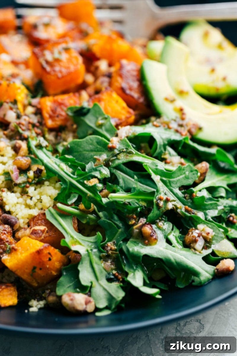 Butternut Squash Bowl: Easy Meal Prep for a Healthy Week Four individual meal prep containers showing pre-portioned butternut squash, couscous, and pecans, ready for fresh additions and dressing, highlighting the convenience of this recipe for weekly meal planning.