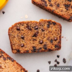 Slices of healthy banana bread, warm and inviting, with chocolate chips scattered throughout.