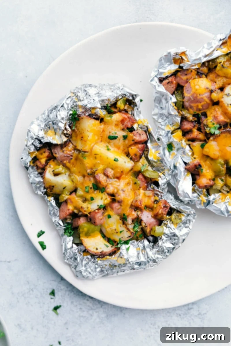 Easy And Delicious Veggie Packed Foil Packs Cheesy sausage and potato foil packs right off the grill.