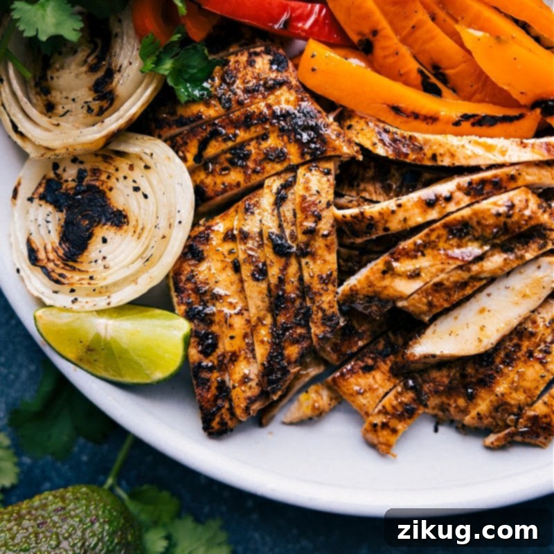 Grilled Chicken Fajitas with Veggies Close-up view of the perfectly grilled chicken fajitas with colorful bell peppers and onions, ready to be served