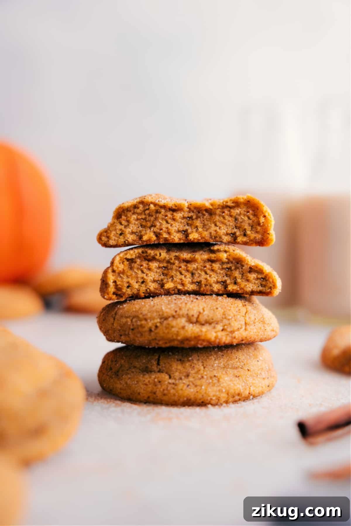 Pumpkin Snickerdoodles with Soft Center Revealed A stack of perfectly baked pumpkin snickerdoodles, with one cookie expertly split open to reveal its irresistibly soft, moist, and chewy interior.