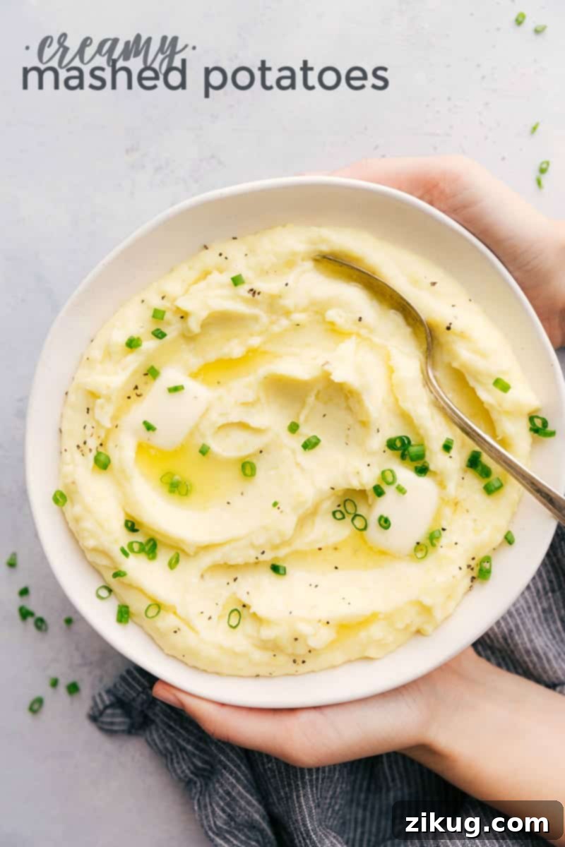 This rich and creamy Mashed Potatoes recipe also includes tips and tricks on how to make the BEST Mashed Potatoes. A bowl of creamy mashed potatoes topped with fresh green onions, ready to serve.