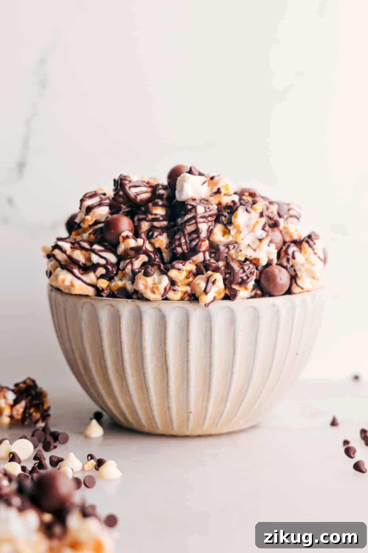 Gourmet-Style Chocolate Popcorn with Malt Balls Chocolate Popcorn: Popcorn and chocolate malt balls mixed together in a bowl, a perfect gourmet snack.