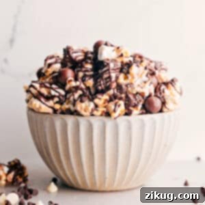 Gourmet Chocolate Popcorn with caramel, three types of chocolate, marshmallows, and malt balls.