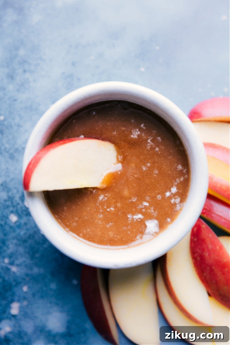 Wholesome Caramel Drizzle 5 A crisp green apple slice perfectly dipped into a bowl of the smooth and rich Healthy Caramel Sauce, ready to be enjoyed as a wholesome snack.