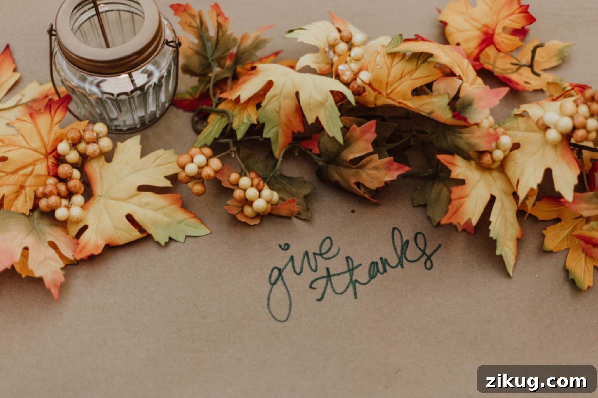 A collection of fall foliage with the message saying "give thanks," illustrating the spirit of Thanksgiving and festive table decor.
