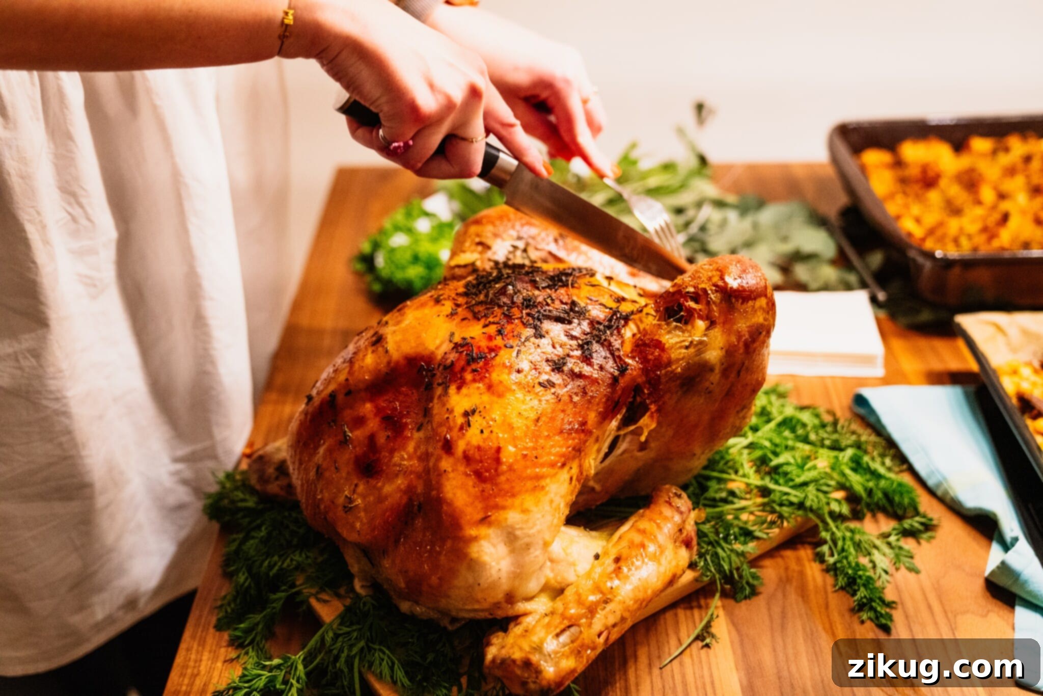 Fully roasted turkey, being carved, showcasing a delicious main course for Thanksgiving dinner.