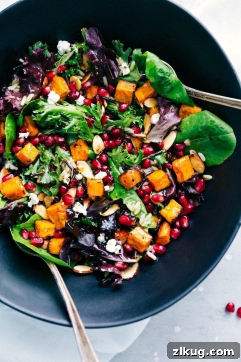 A vibrant bowl of pomegranate and wild rice salad, a refreshing and colorful addition to any Thanksgiving dinner menu.