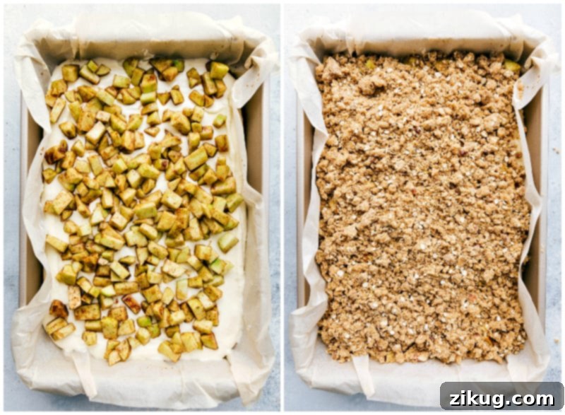 Apple and Cheesecake Layers Topped with Streusel A layered dessert with the apple layer on the cheesecake, all topped with a crumbly streusel, ready for baking.