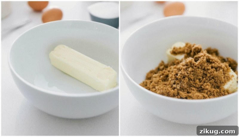 Process shot of making Oatmeal Cookies, showing softened butter being creamed with brown and white sugar in a mixing bowl.