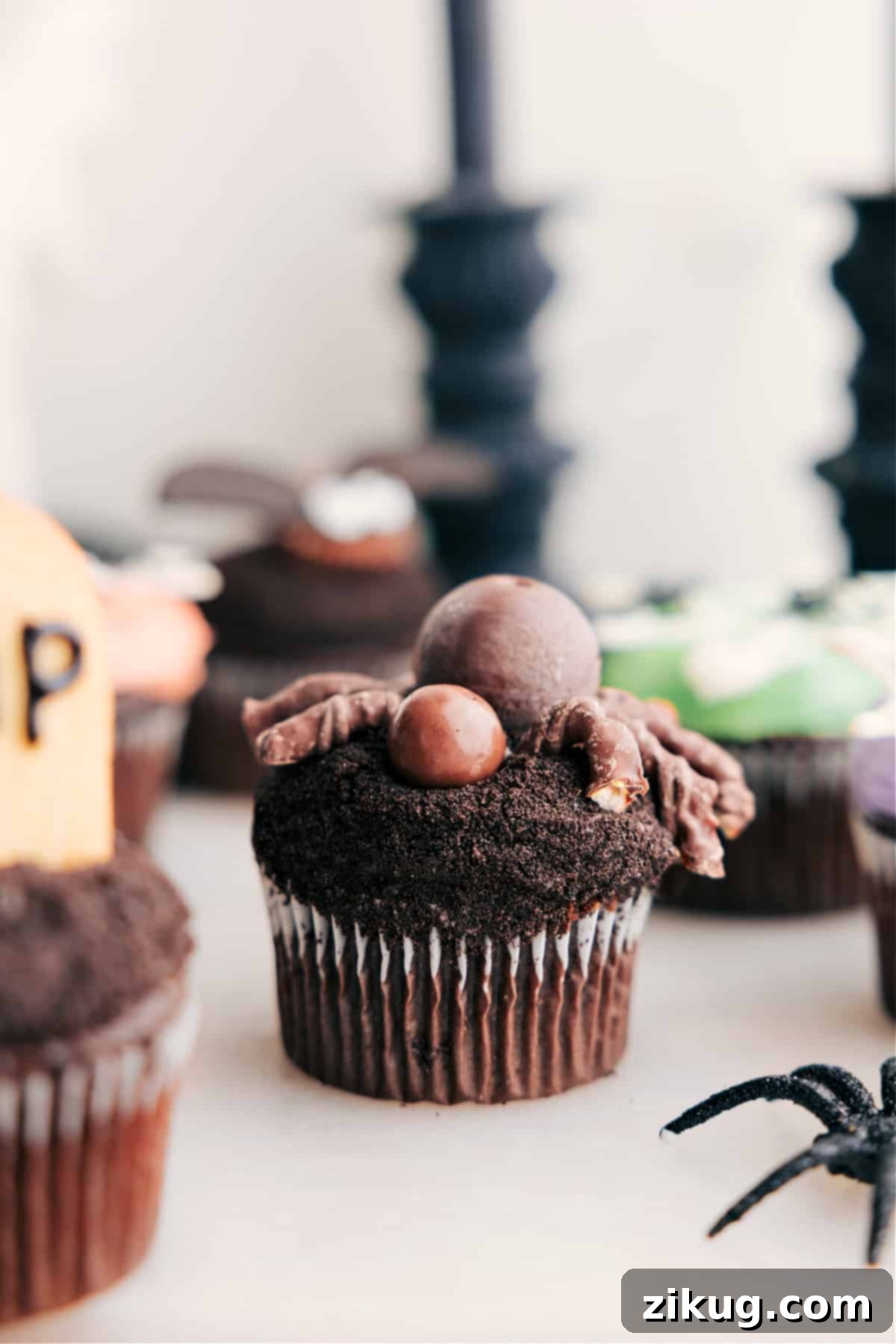 A festive spider dessert for a spooky treat, featuring a chocolate body and pretzel legs.