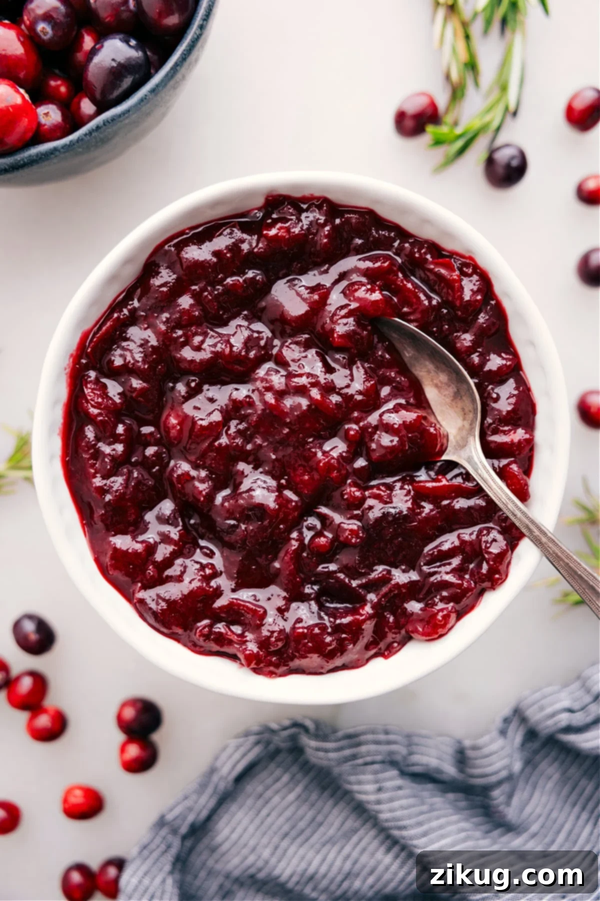 Cranberry Sauce in a bowl, ready to serve at your holiday spread, glistening with rich color and texture.