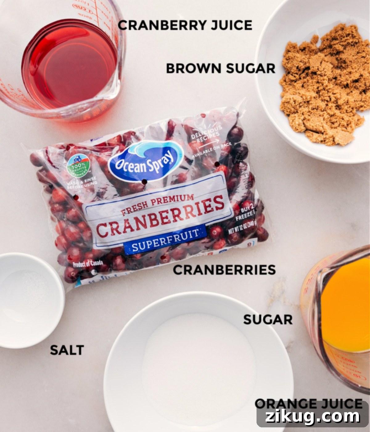 This recipe's ingredients are prepped for easy assembly: cranberries, sugar, orange juice, brown sugar, cranberry juice, and salt, showcasing their freshness and quality.