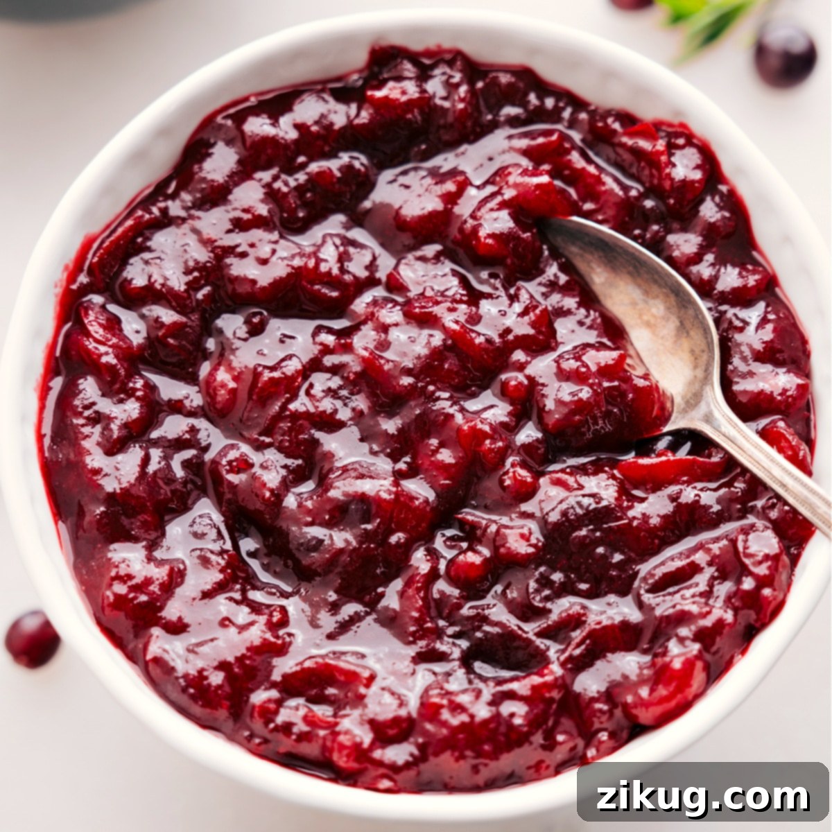 Cranberry sauce in a bowl with a spoon, ready to serve alongside your holiday turkey and other festive dishes.