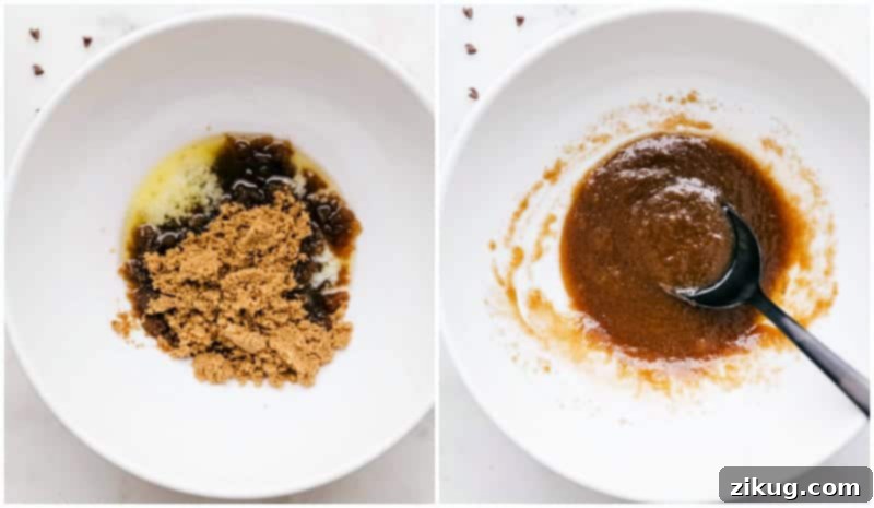 A close-up image of a spoon vigorously mixing together deeply melted unsalted butter with both white granulated sugar and light brown sugar in a clear glass bowl, creating a smooth, creamy, and perfectly blended base for the edible cookie dough recipe preparation.