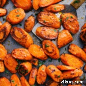 Pan of roasted and seasoned carrots with a golden, caramelized finish.