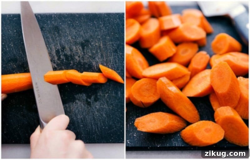 Carrots being chopped on a cutting board, prepped for roasting.
