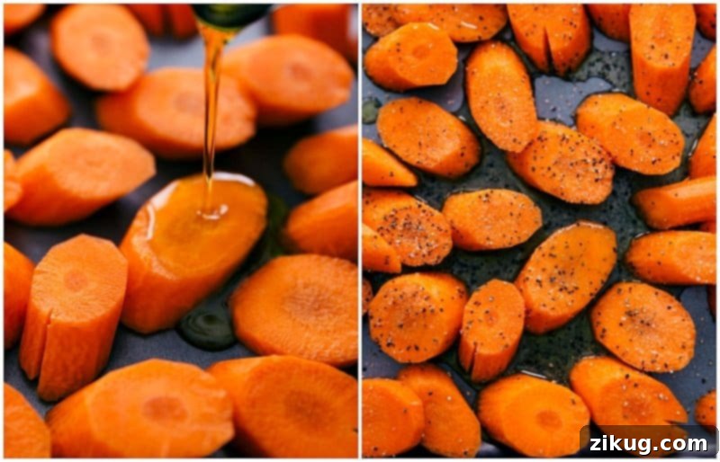 Olive oil and a blend of seasonings being tossed with chopped carrots on a baking sheet, preparing them for roasting.