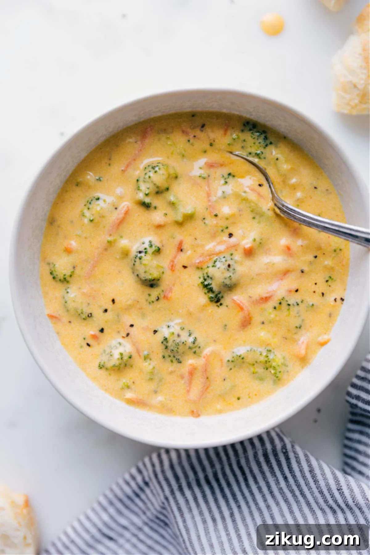 A steaming bowl of rich, creamy Homemade Broccoli Cheddar Soup, garnished with fresh broccoli florets and shredded cheddar cheese, ready to be savored.