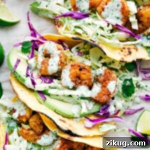 A finished shrimp taco on a wooden board, showcasing its vibrant ingredients.