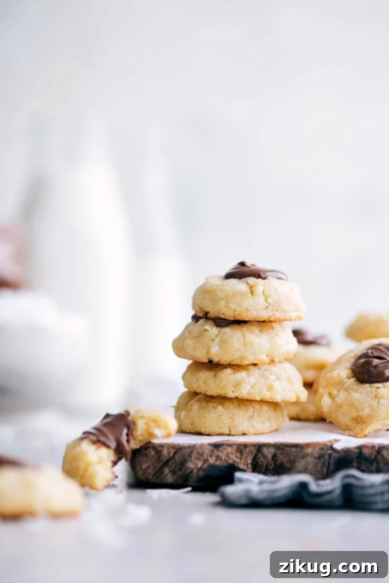Coconut Thumbprint Cookies: The Ultimate Macaroon-Shortbread Fusion with Nutella! Photo of a stack of Coconut Thumbprint Cookies