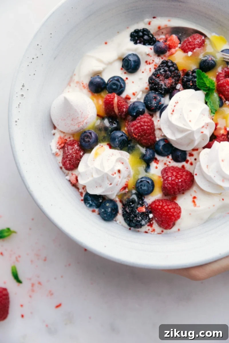 Meringue Cookie Recipe in a bowl with yogurt, berries, and lemon curd, showcasing a perfect dessert combination.