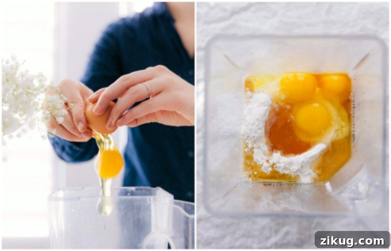 Cracking eggs directly into a blender jar where milk and other liquid ingredients are already waiting, preparing for a smooth crepe batter.